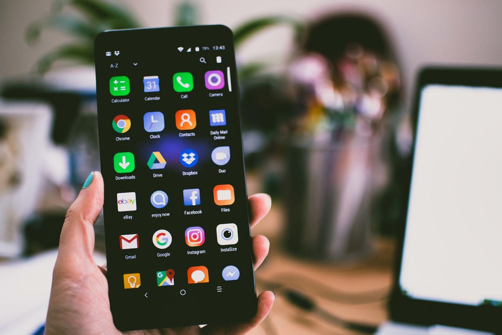 A hand holding an Android phone