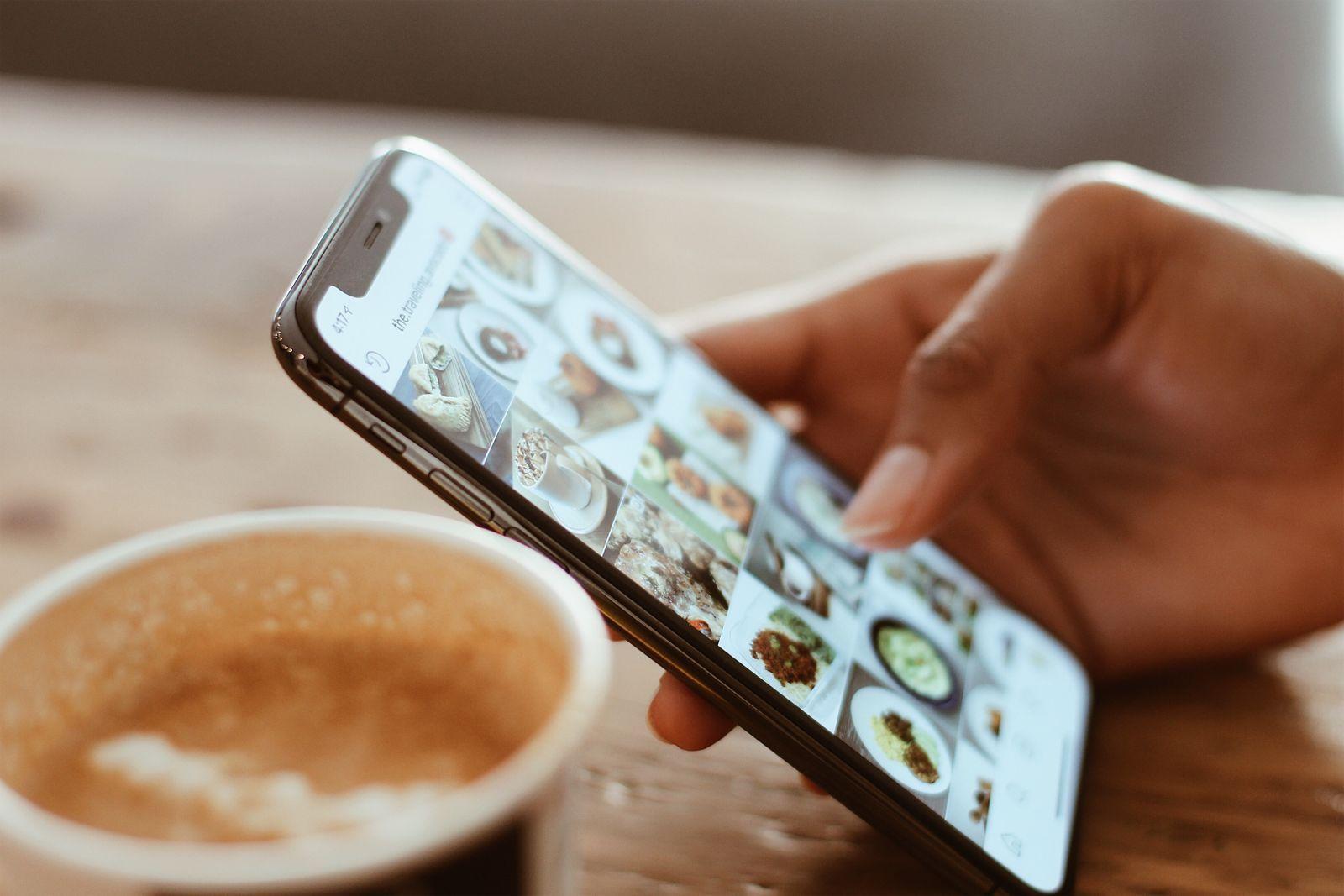 Browsing saved reads on a phone over coffee