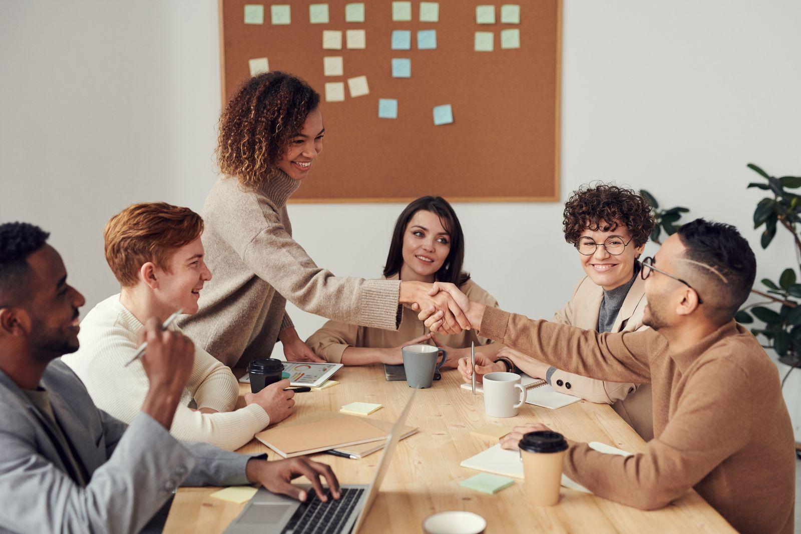 A startup team celebrating around a table